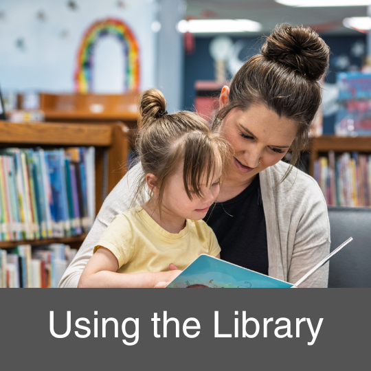 woman reading to a young girl